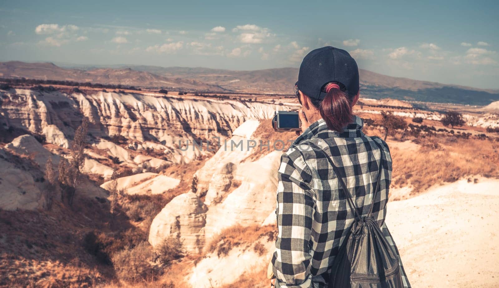 Tourist photographing canyon in Cappadocia, Turkey by GekaSkr