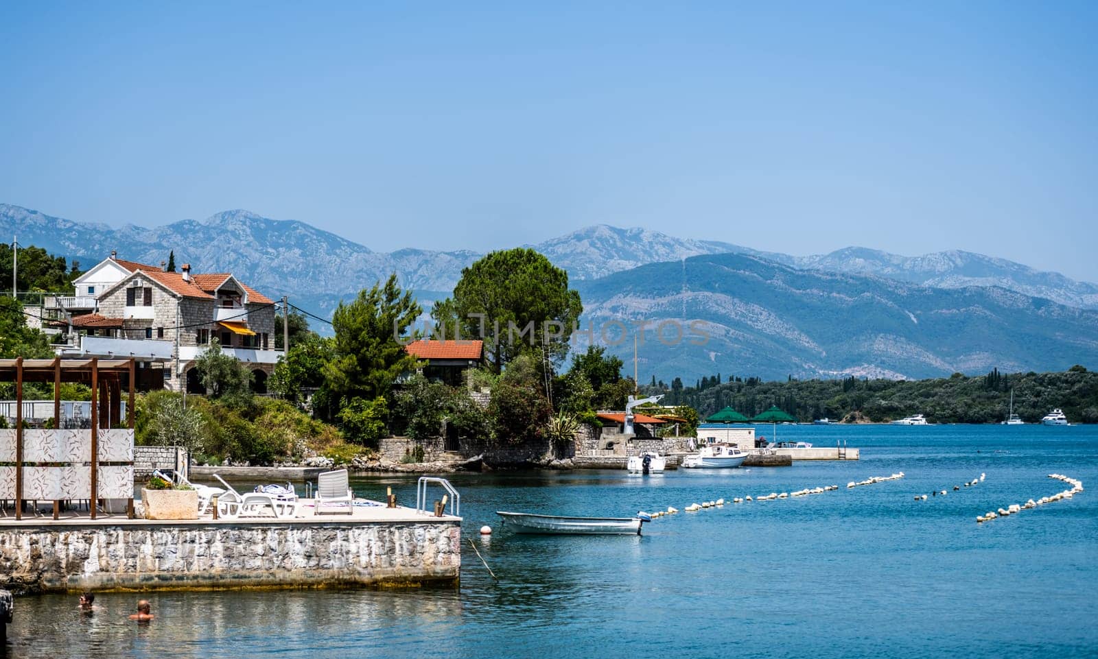 Beautiful Mediterranean architecture in Montenegro from Adriatic sea view. Scenic town with mountains on background