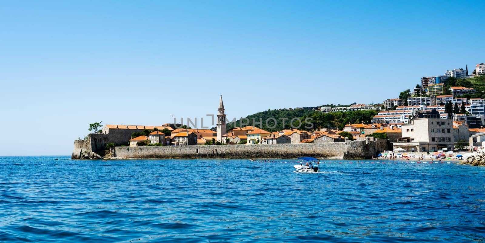 Montenegro city view with old buildings from Adriatic sea. Ancient Mediterranean architecture with mountains and beautiful nature