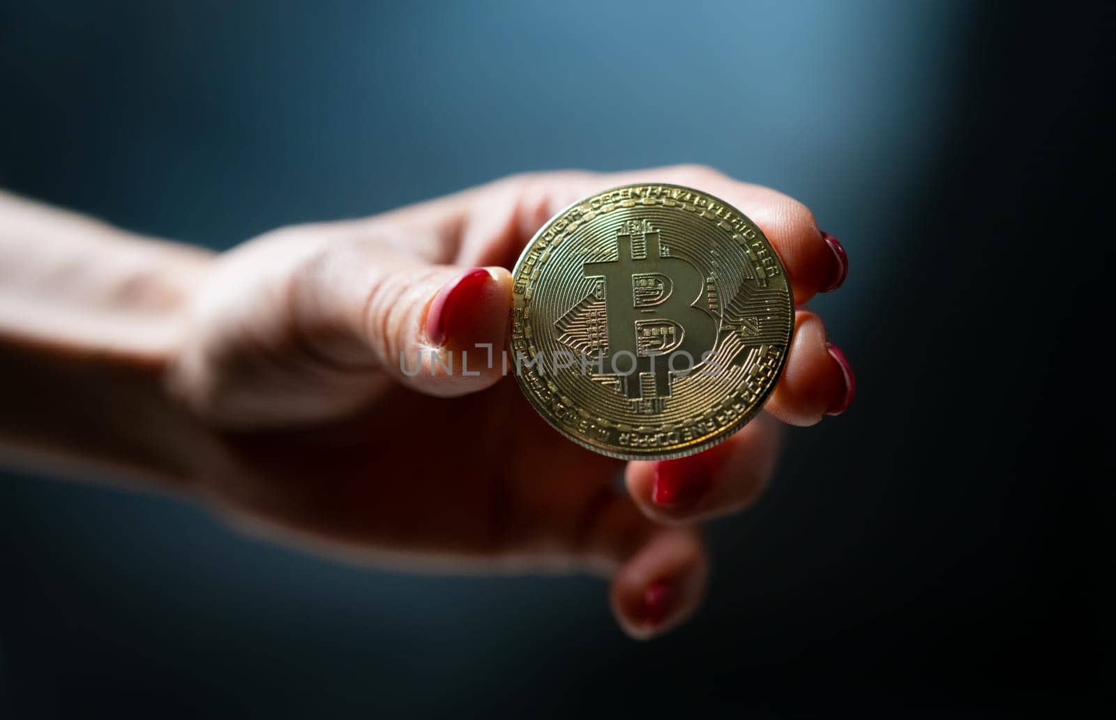 Female hand holding golden bitcoin virtual currency coin. Btc digital cyberspace money of future and symbol of mining and blockchain technology
