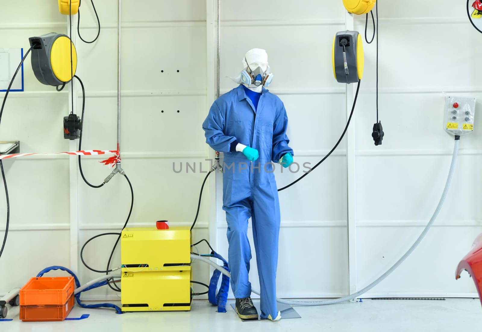 Dummy mannequin in respiratory mask and uniform in the area for car coloring