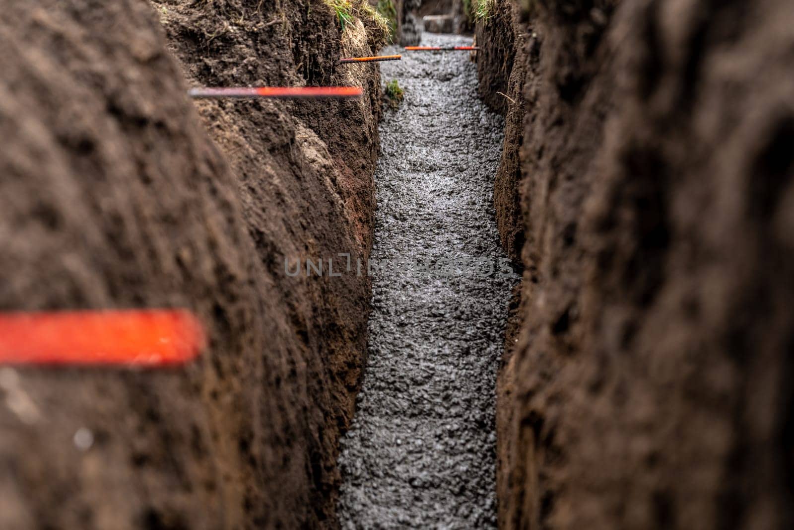 cementing the foundation in the ground when building a house.