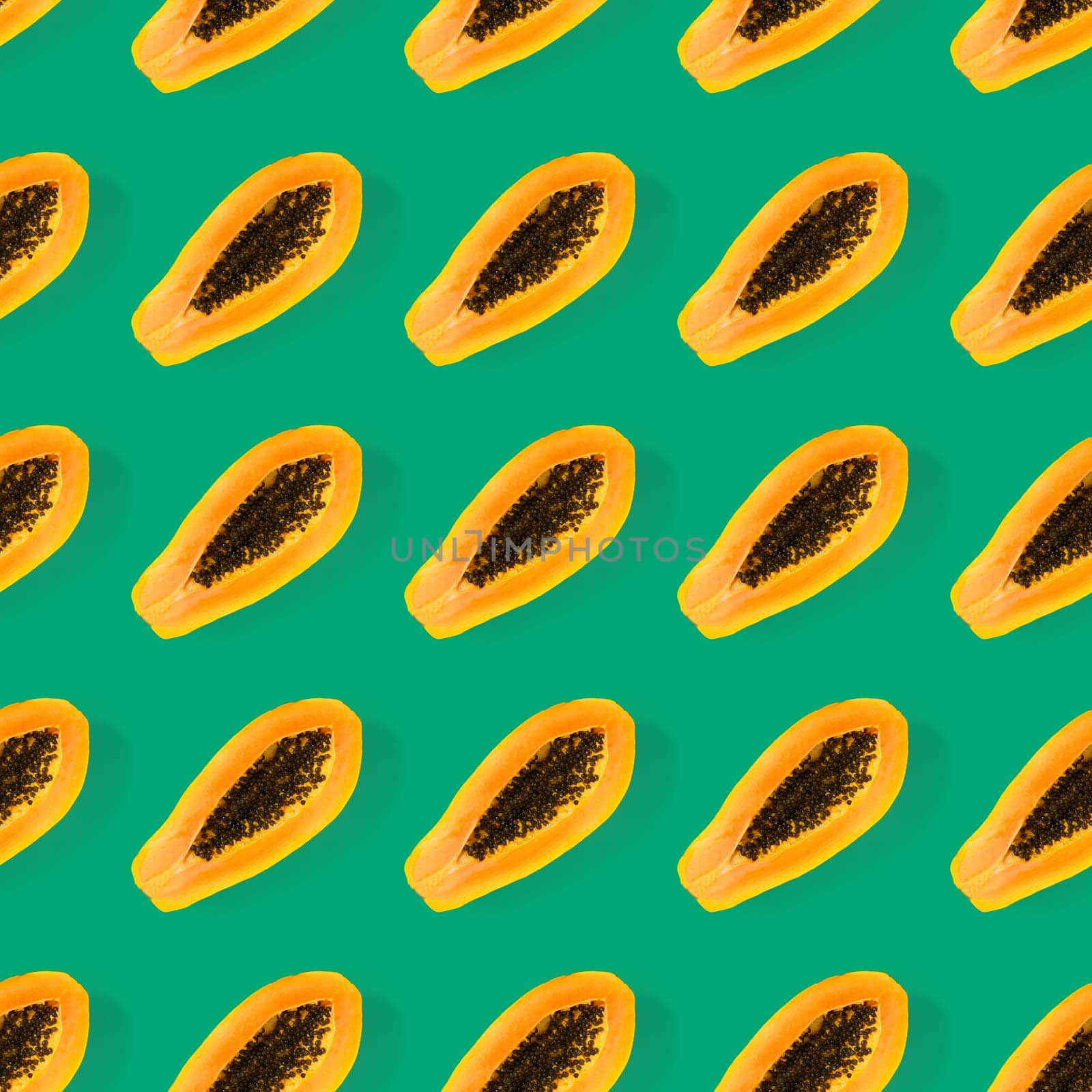 Fresh ripe papaya seamless pattern on green background. Tropical abstract background. Top view. by PhotoTime