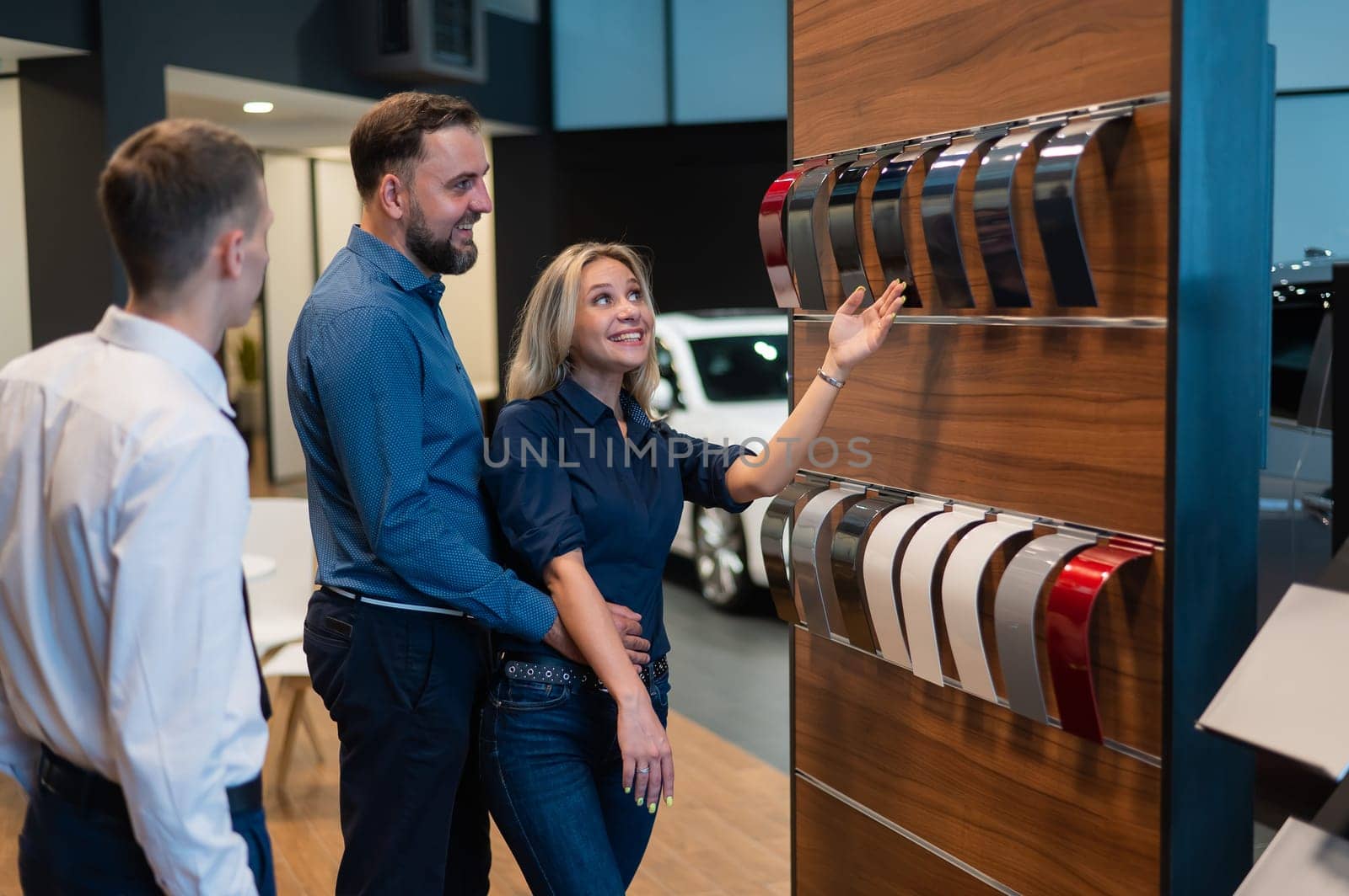 The seller helps a married couple choose the color of a new car. by mrwed54