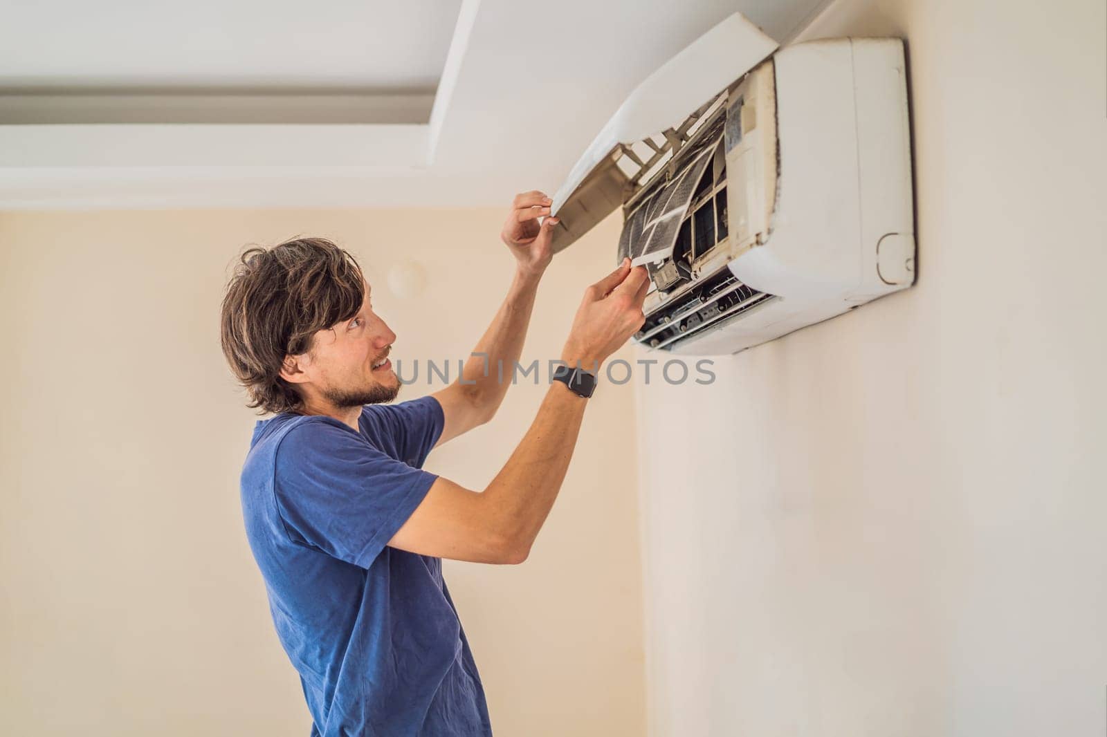 technician service removing air filter of the air conditioner for cleaning.