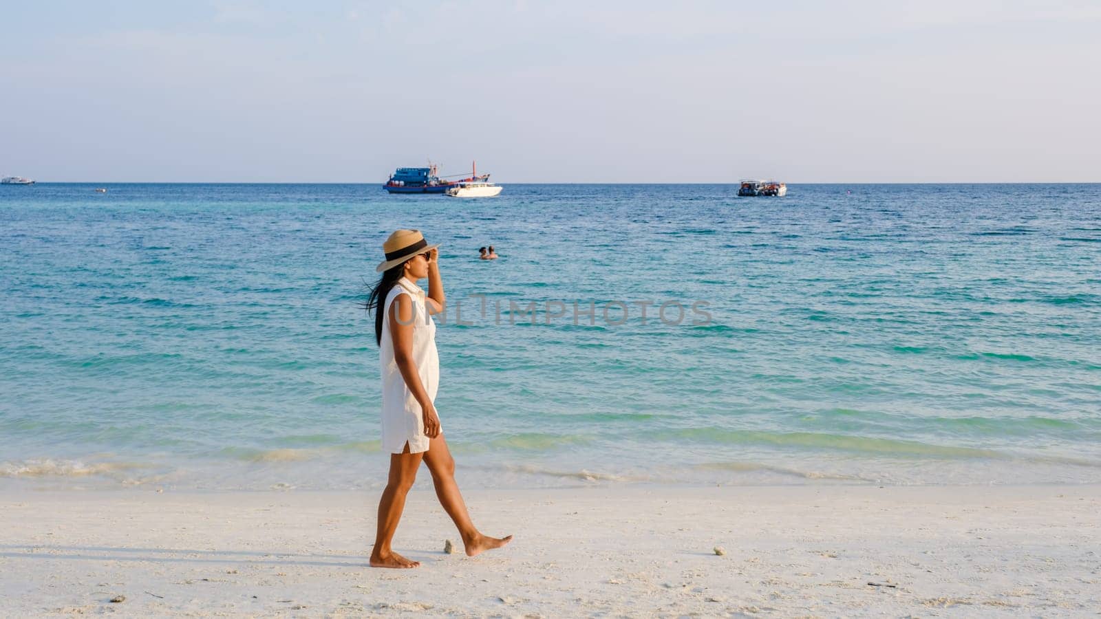 Asian women walking on the beach during sunset at Ko Lipe Island Thailand