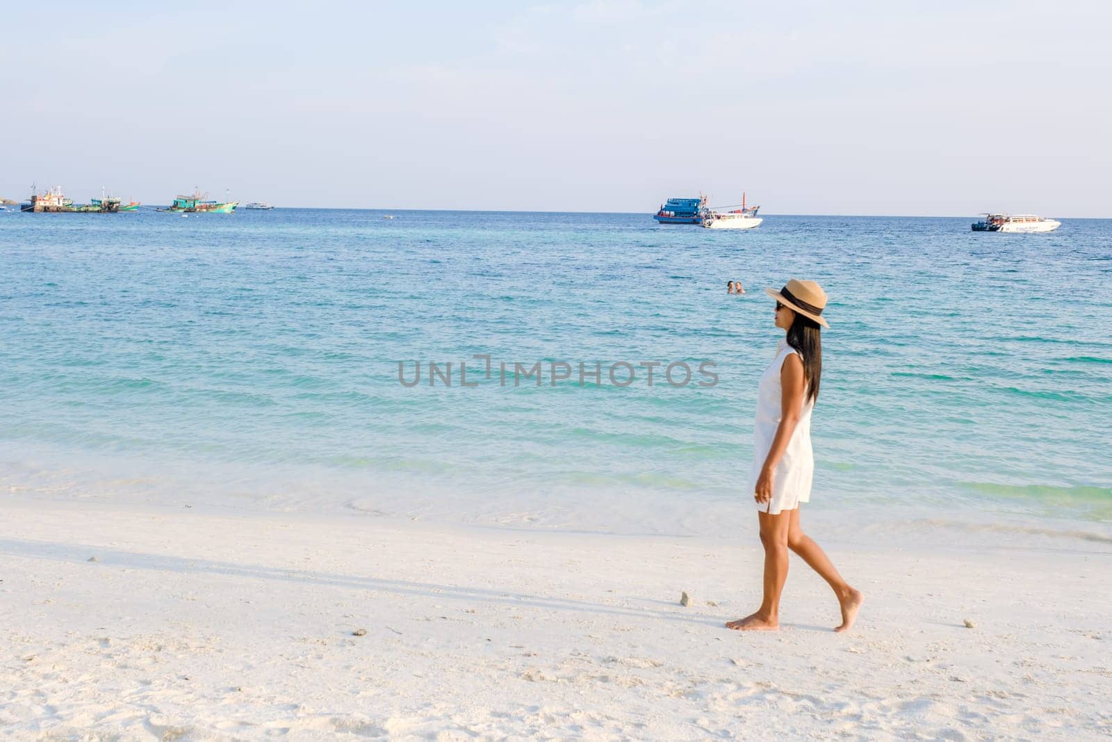 Asian women walking on the beach during sunset at Ko Lipe Island Thailand