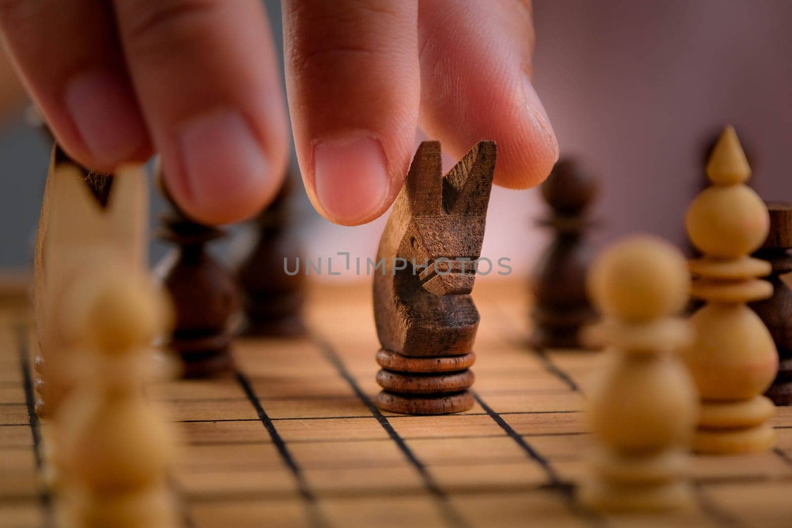 Close-up of businessman hands playing chess game. Concept of business strategy and tactic.