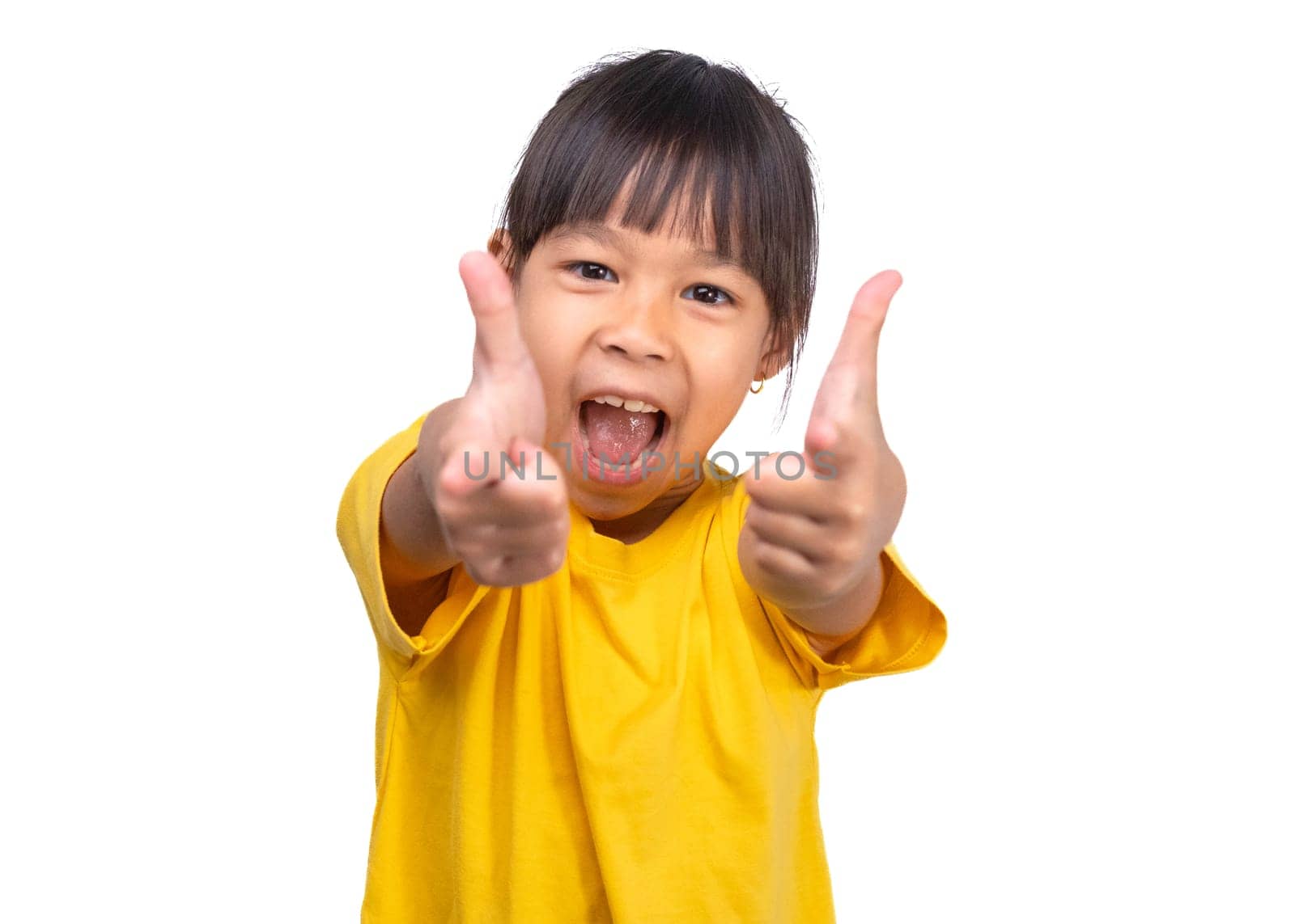 Young cute Asian girl pointing finger forward standing on white background. Cute preschool child looking at camera pointing finger at copy space. indoor studio shot
