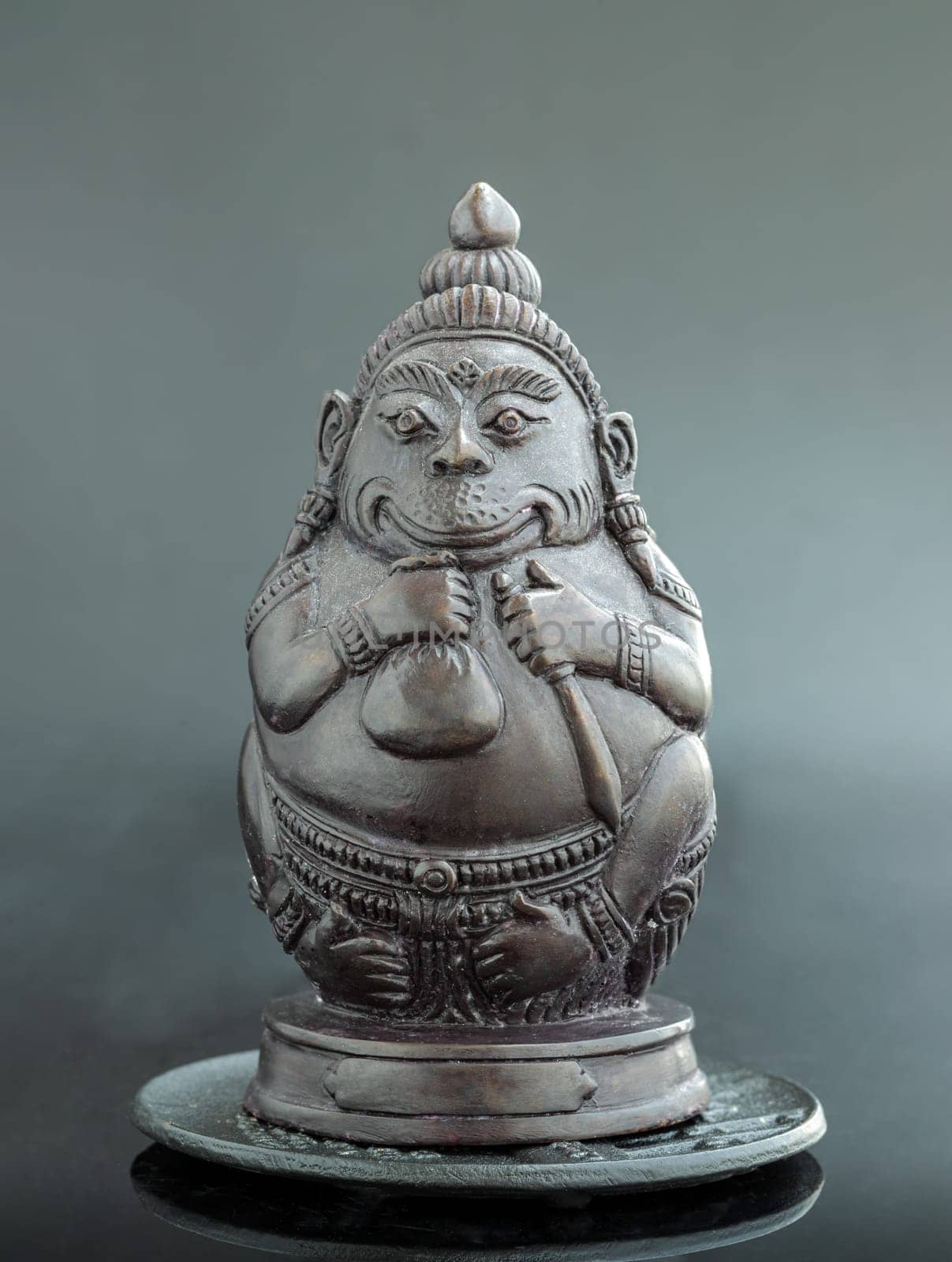 Figurine of Phali, (The Unbeatable Money King) Sculpture Statue on Dark Background. In Ramayana, Phali is the strongest monkey king who got blessing from God Shiva. Space for text.