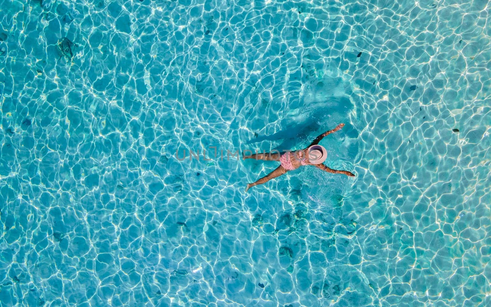 drone view at a woman swimming in the blue turqouse colored ocean of Koh Kradan island in Thailand by fokkebok