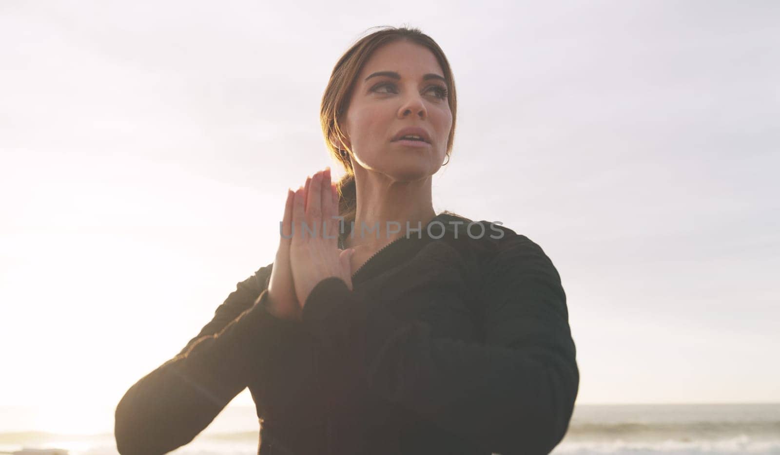 Yoga is what helps us to better ourselves. a woman practising yoga on the promenade