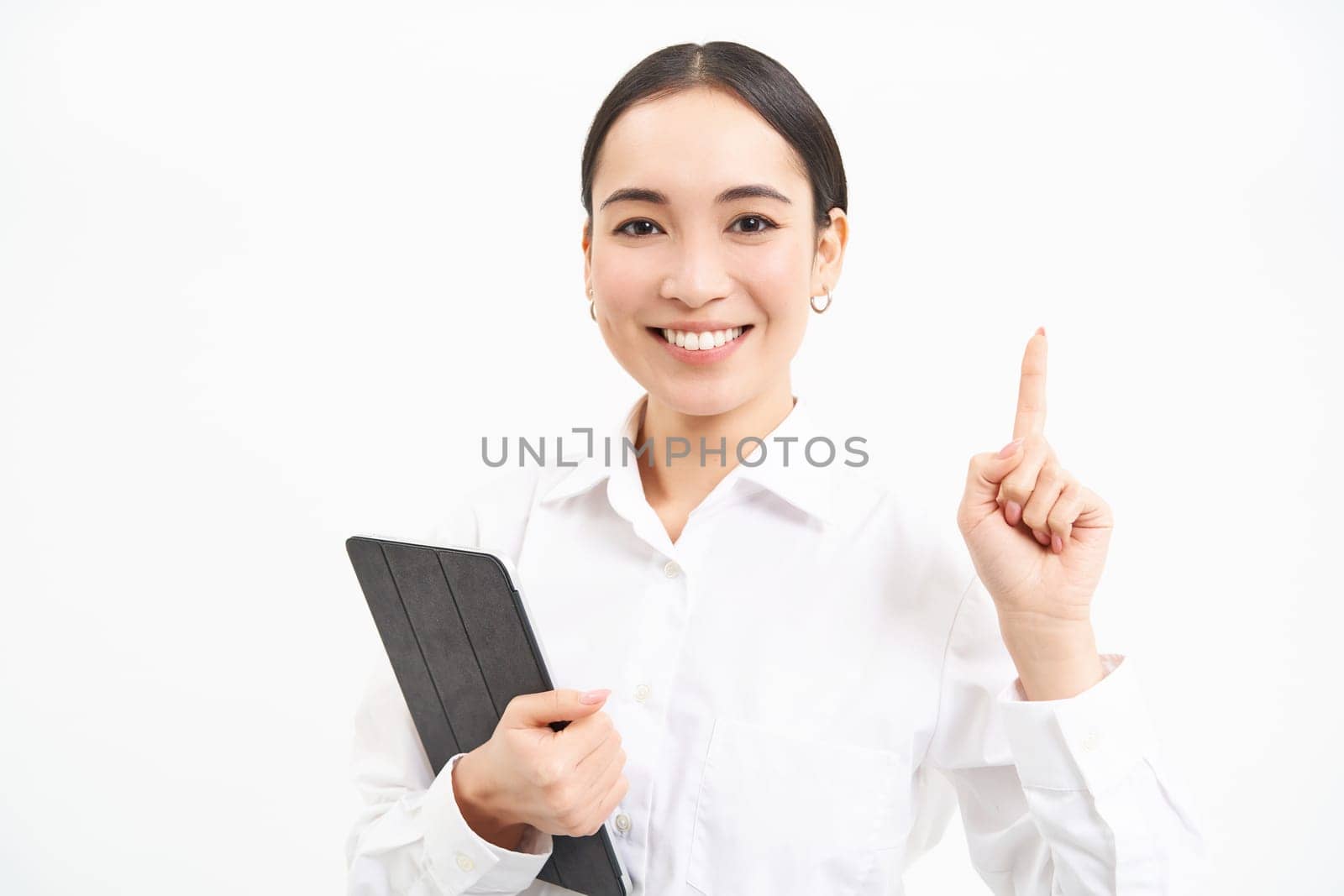 Corporate asian woman, manager using digital tablet, working on gadget, checking charts, company statistics, standing over white background.