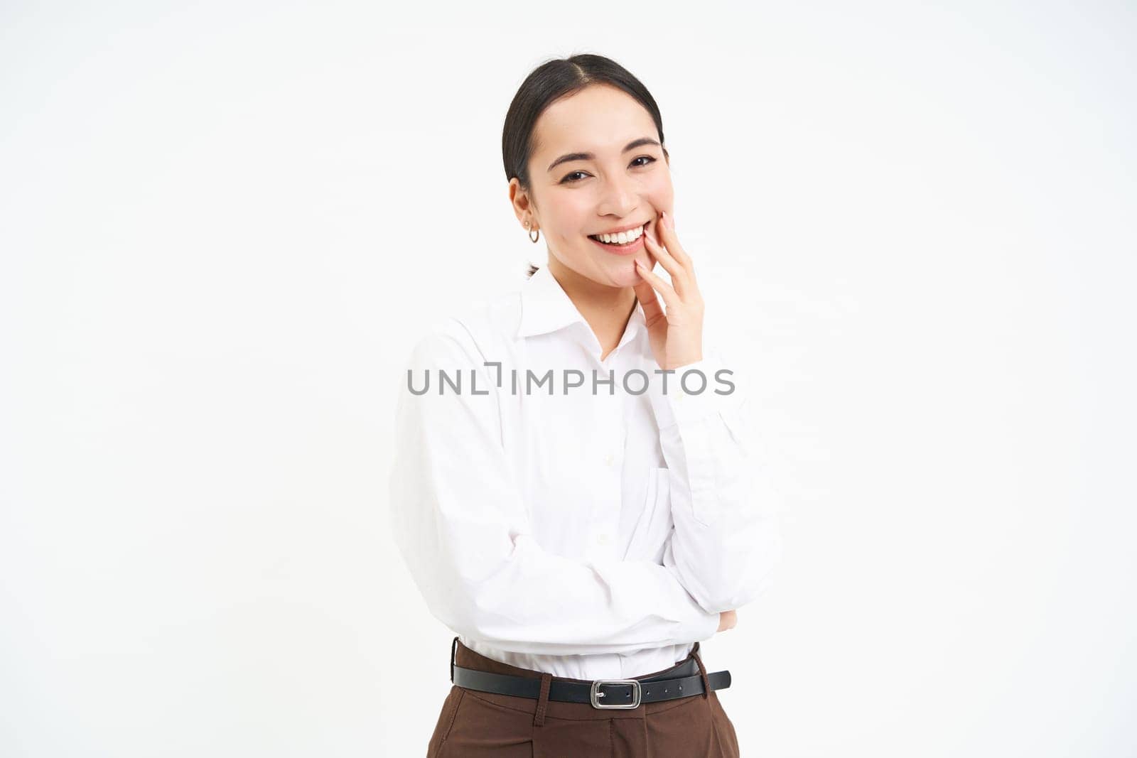 Portrait of smiling korean woman, businesswoman with carefree happiness on her face, white studio background by Benzoix