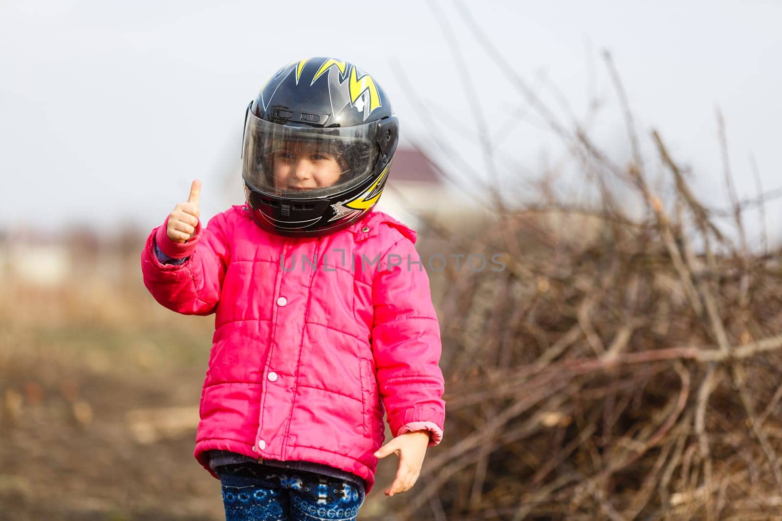 Little girl in a motorcycle helmet. by Andelov13