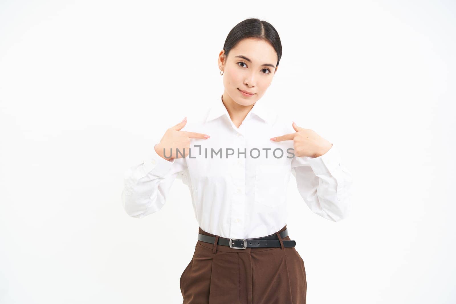 Business and corporate concept. Confident asian woman, saleswoman points at herself with serious face, white background.