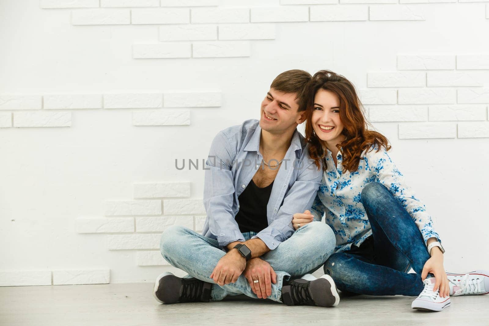 Portrait of young couple smiling on white background. by Andelov13