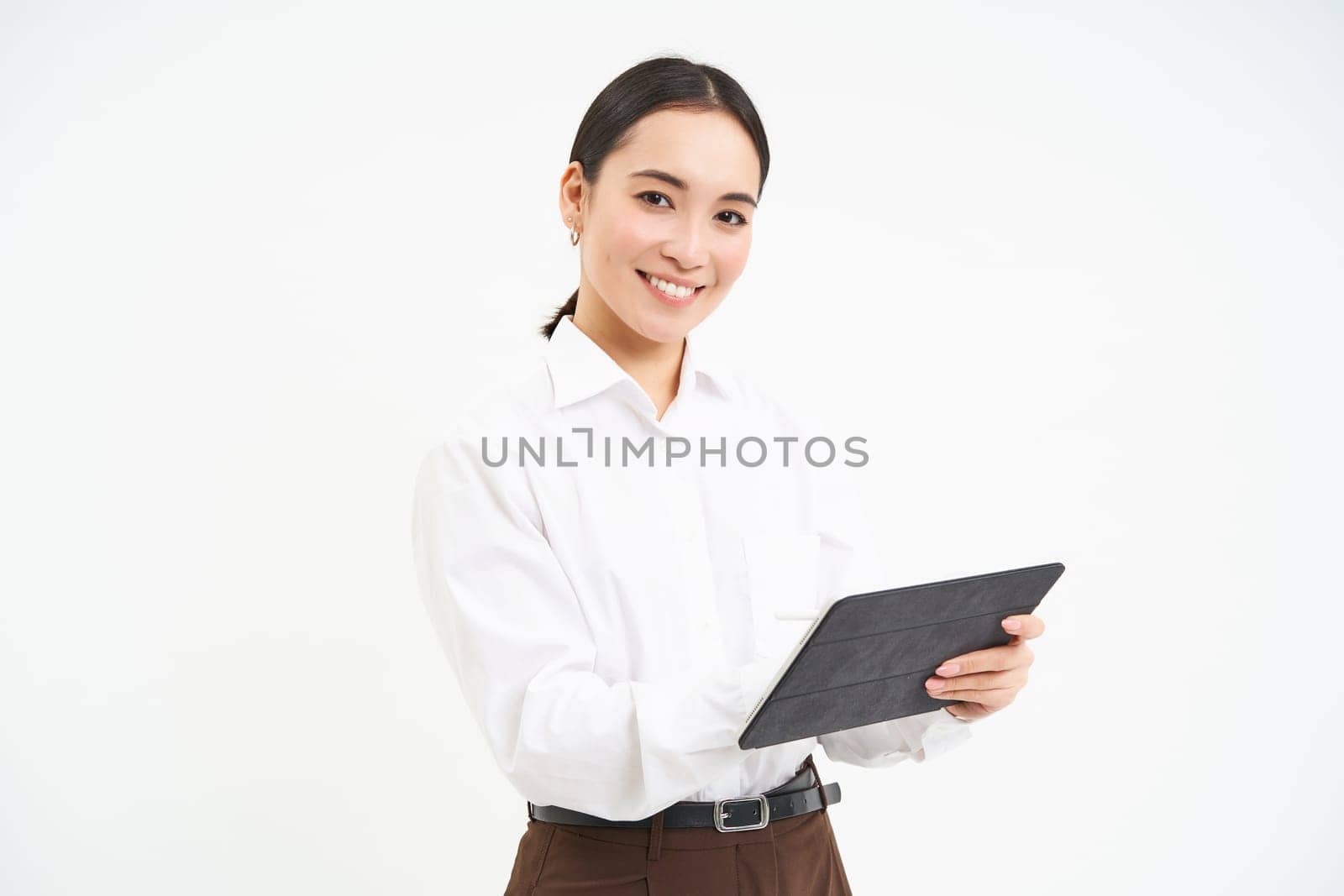 Asian woman professional, standing with digital tablet, working on project, writing down notes for business meeting, standing isolated over white background by Benzoix