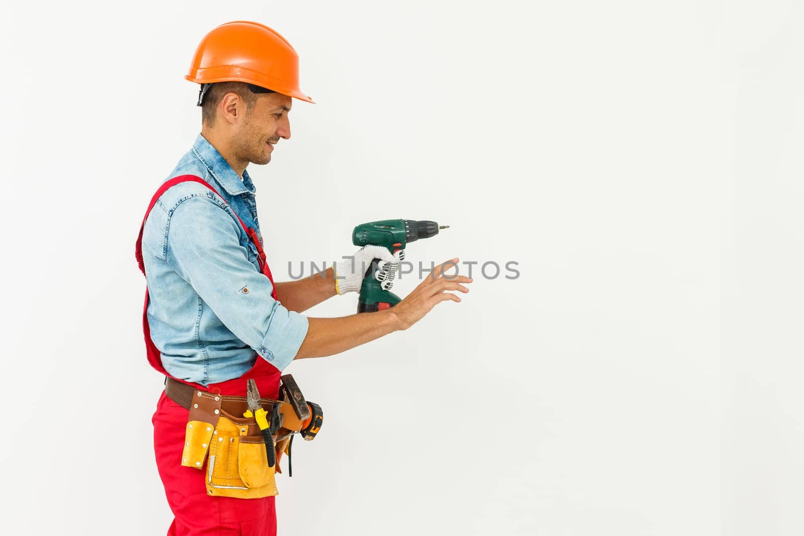 Construction worker with helmet and screwdriver.