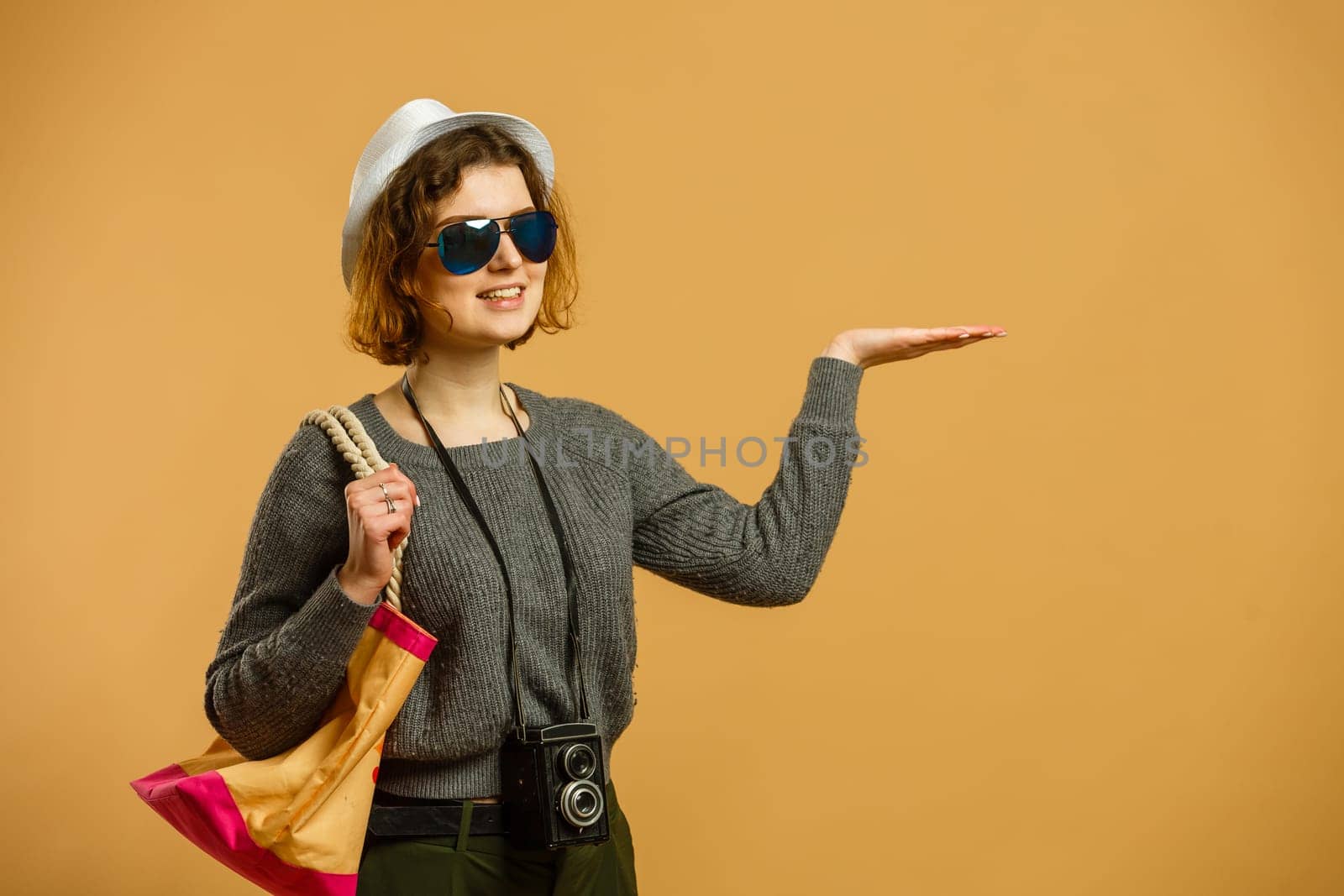 Traveler tourist woman in casual clothes hat camera point finger.