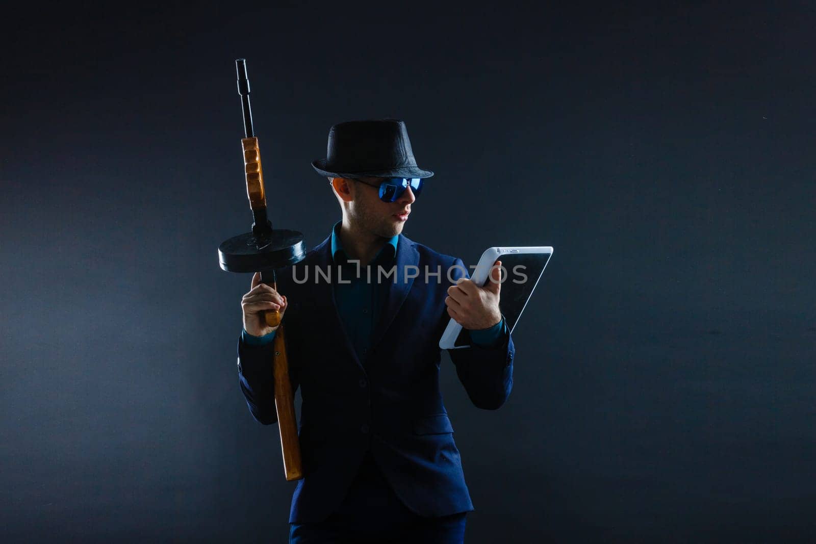 Mature Business Man Holding Gun on a dark background by Andelov13