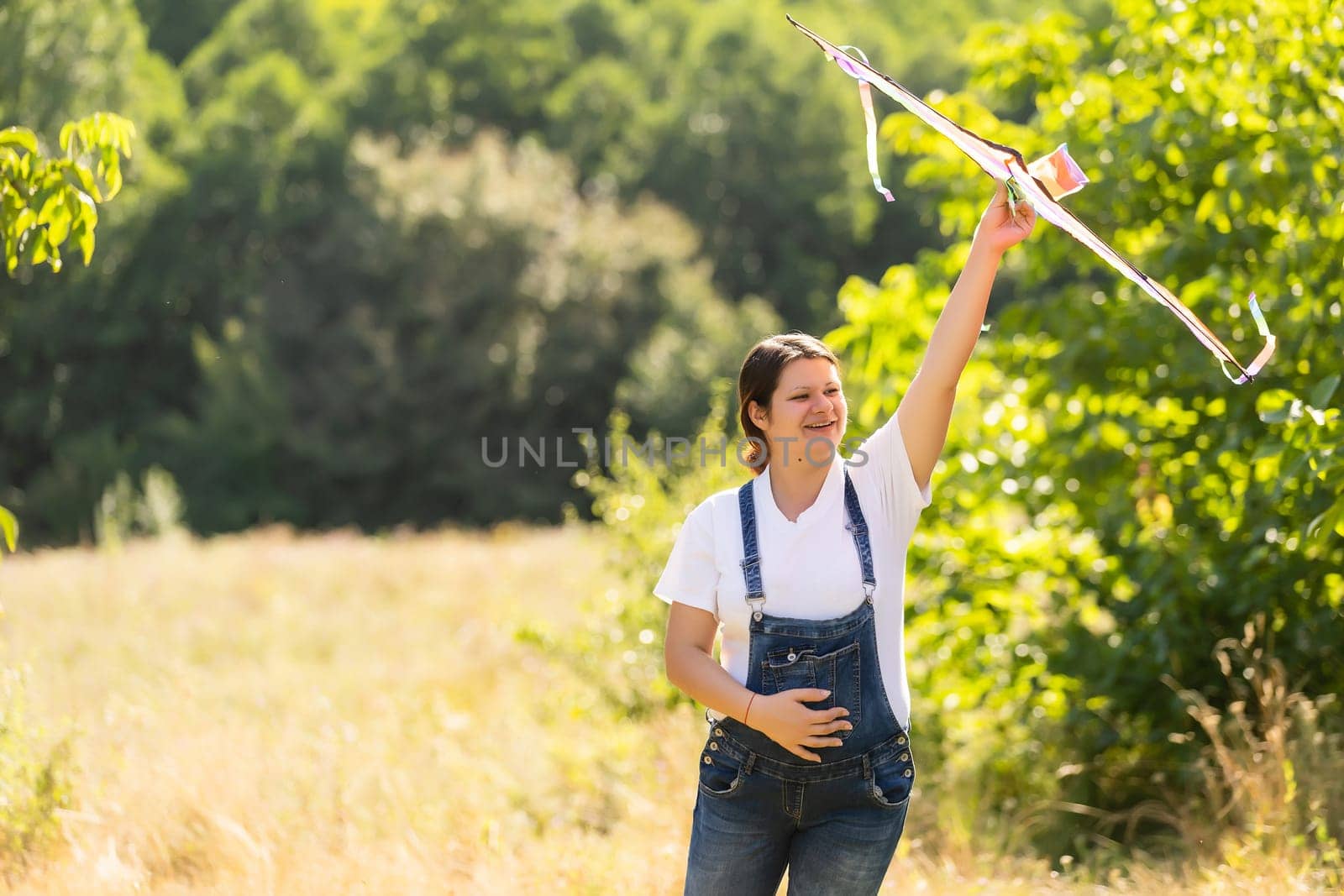 A pregnant woman runs into the sky kite by Andelov13