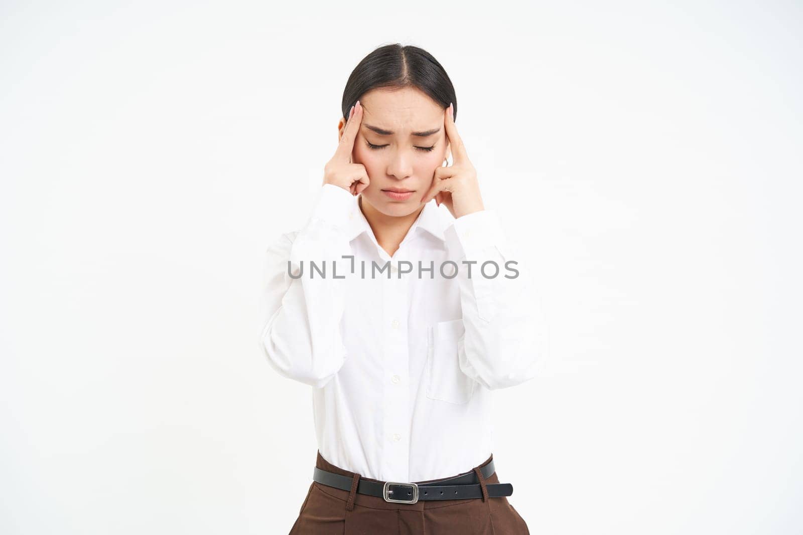 Tired corporate woman, office manager holds hands on head, has headache or migraine, stressed at work, whtie background by Benzoix