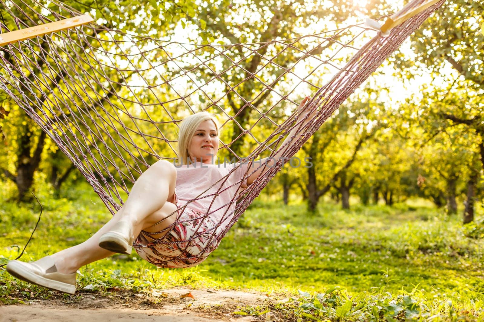 attractive woman 30 years old in a hammock. Outdoor.