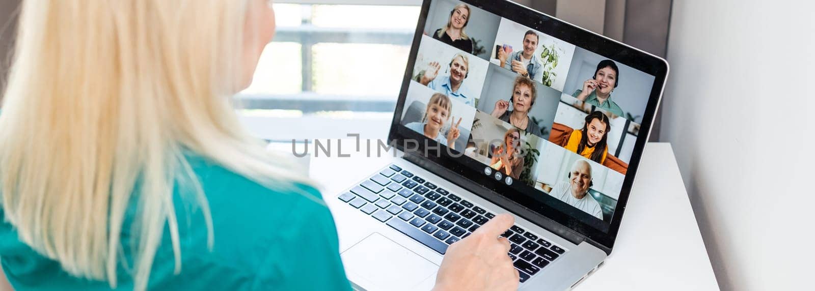 Woman having video chat with colleagues at table in office, closeup by Andelov13