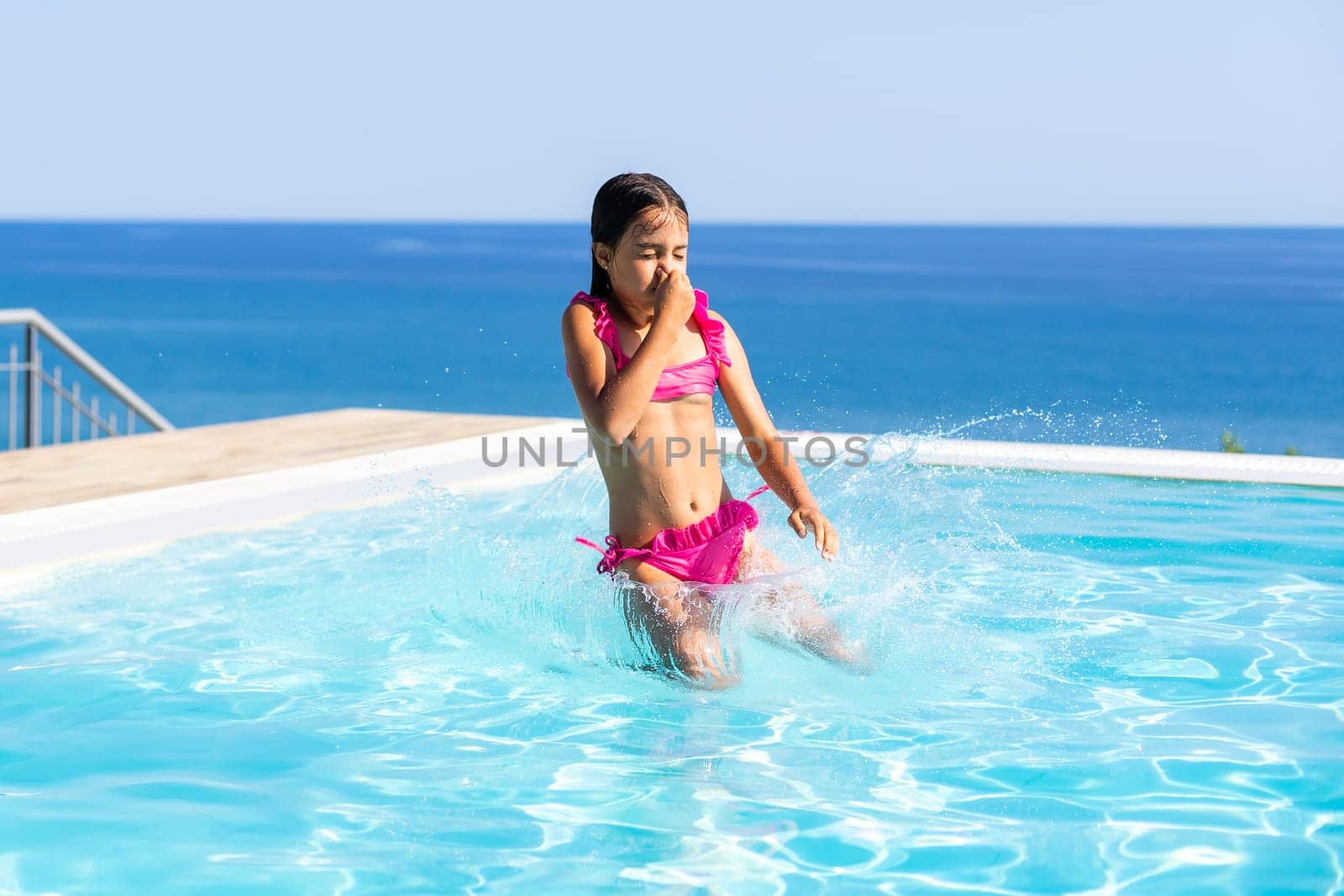 Young girl posing near swimming pool by Andelov13