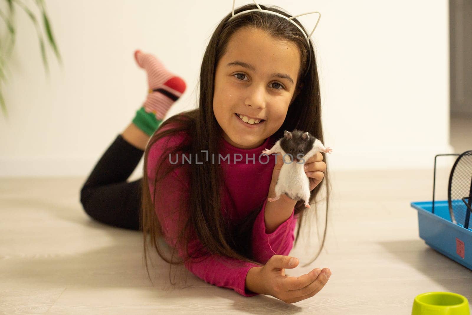 little girl holding a hamster