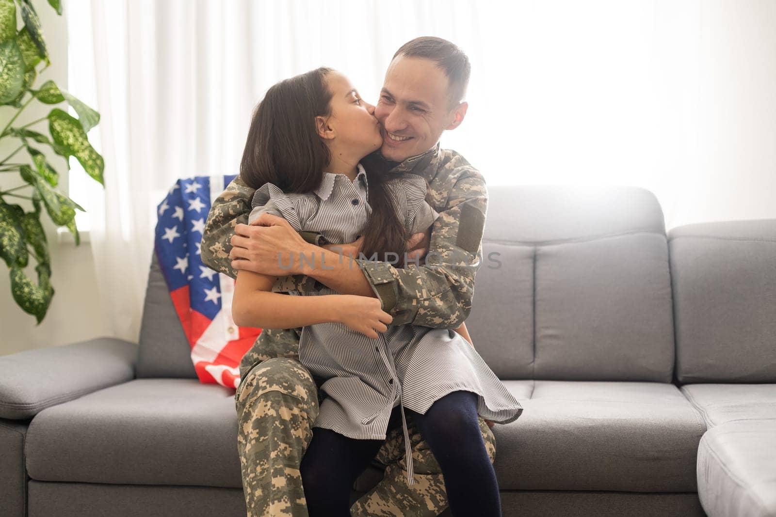 veteran and his daughter with a flag.