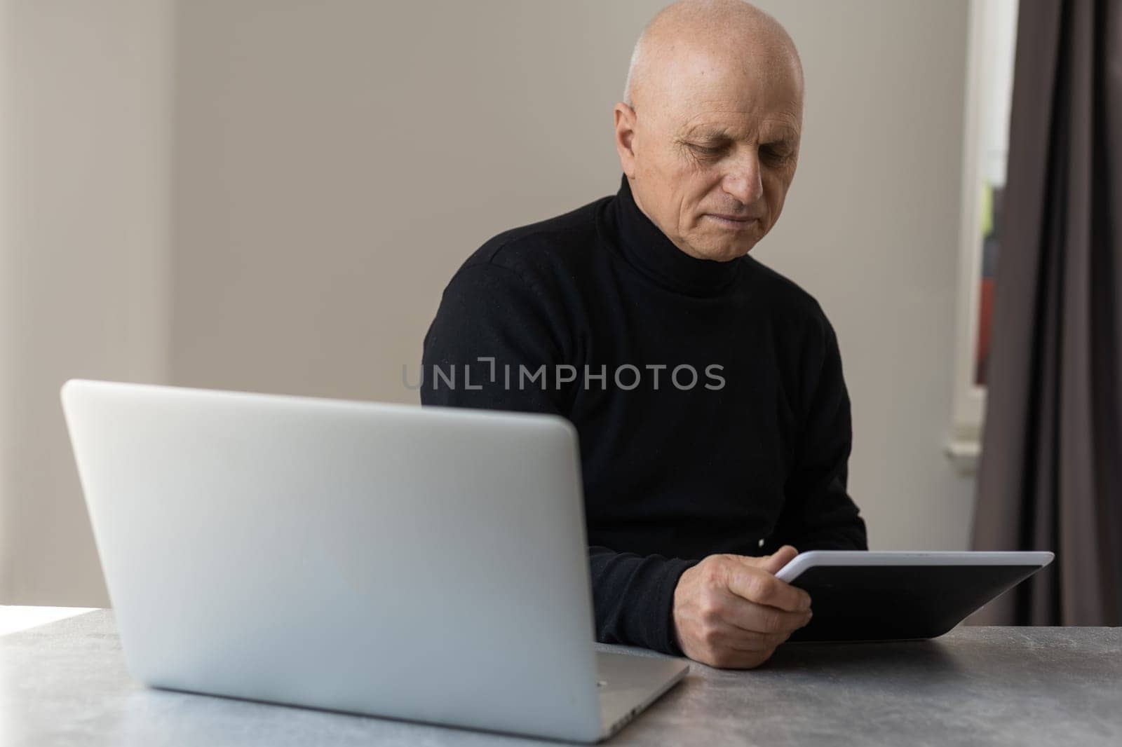 Caucasian old senior stress upset male businessman entrepreneur sitting at working desk having headache after reading graph chart report and contract paperwork document at working desk in office by Andelov13