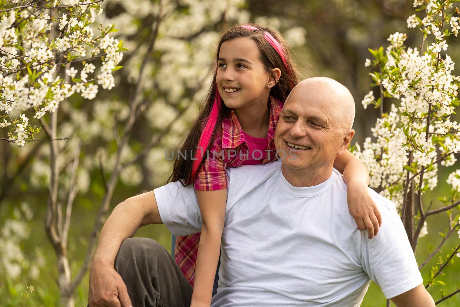 Adorable cute girl and grandfather walk in park. by Andelov13