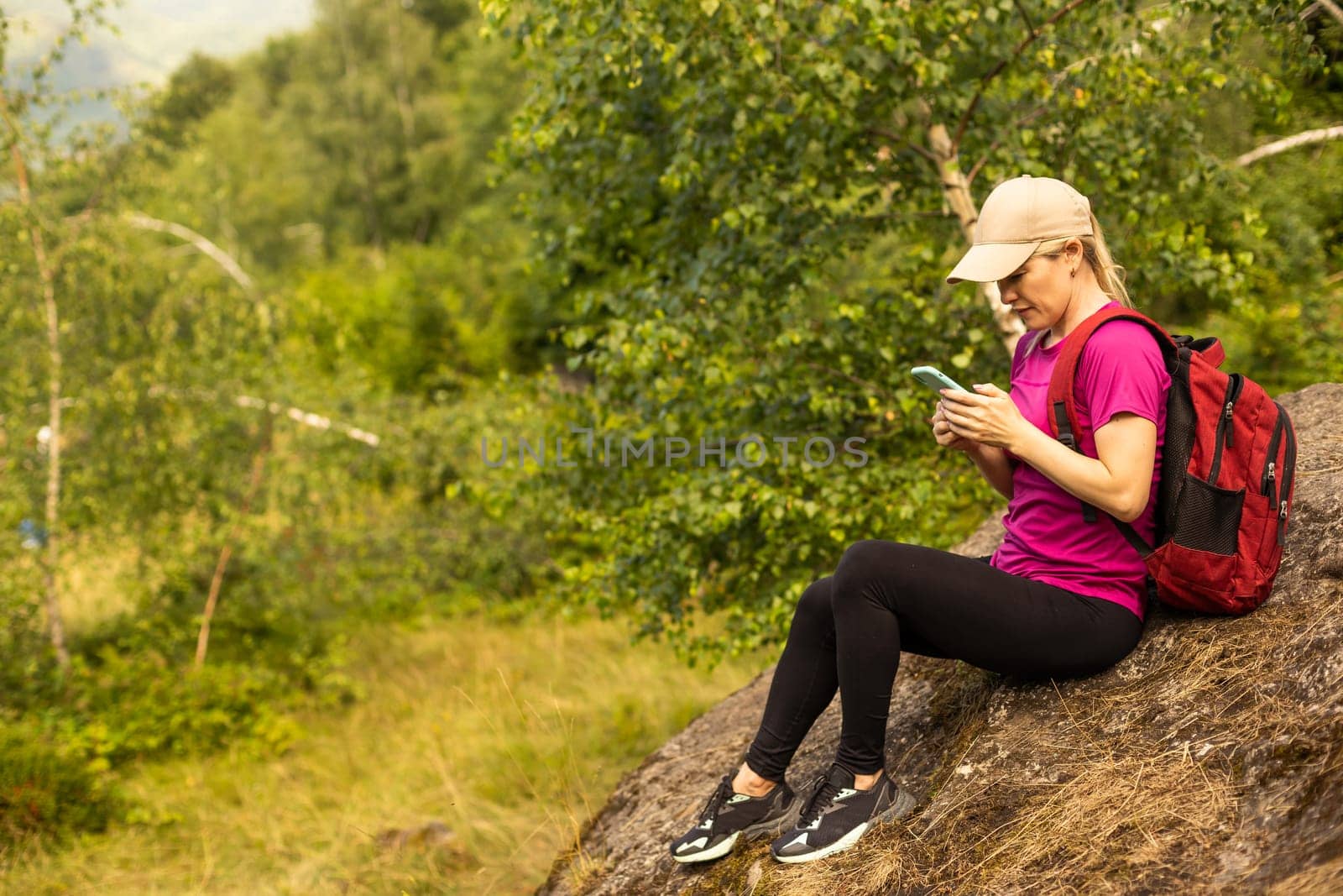 young woman hiker use smart phone mountain