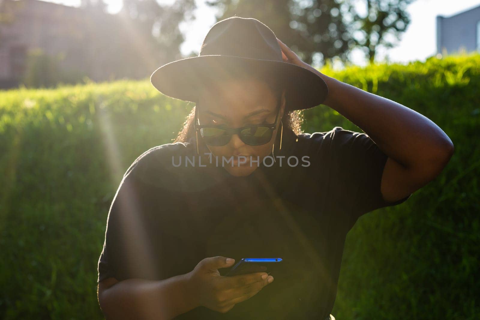 African american woman browsing social networks in the city - millennial generation and urban concept by Satura86