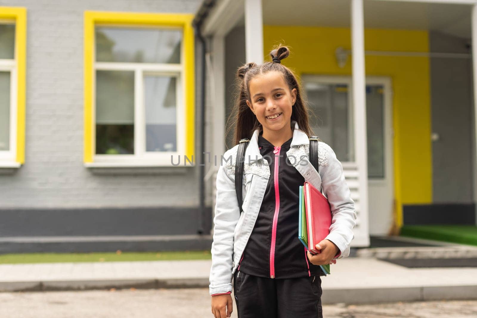 Back to school - lovely schoolgirl on the way to the school