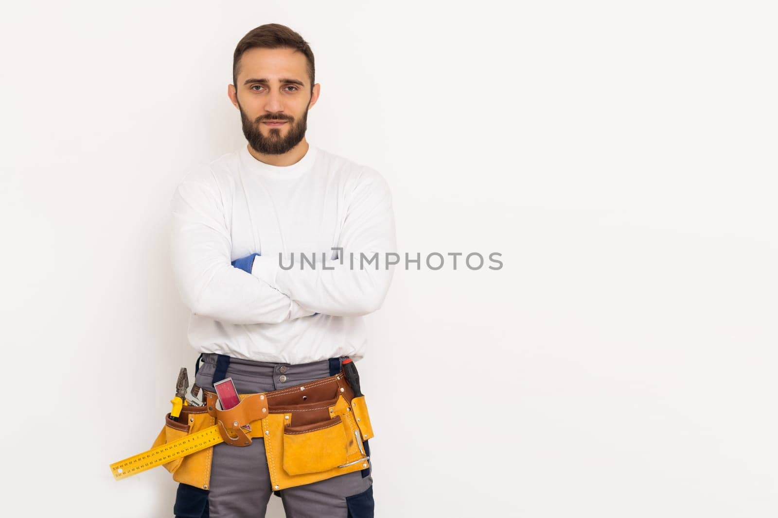 Male worker in a uniform posing isolated on white background.