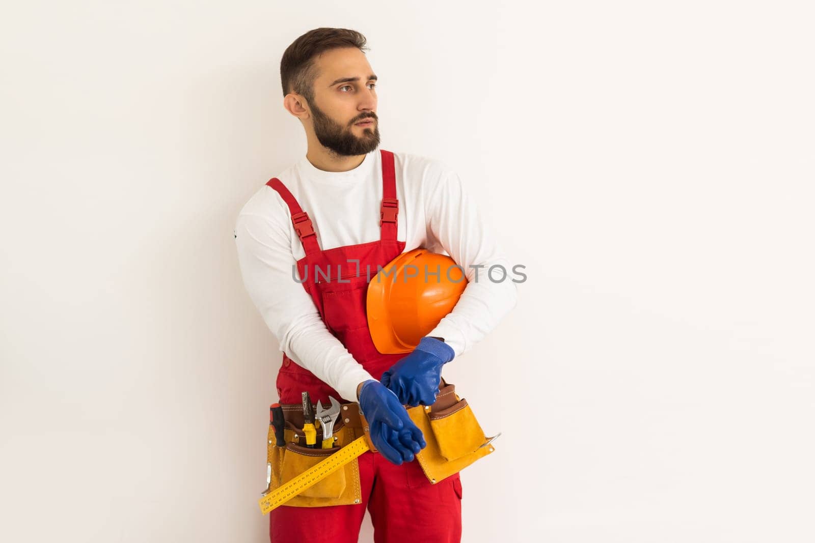 Male worker in a uniform posing isolated on white background.