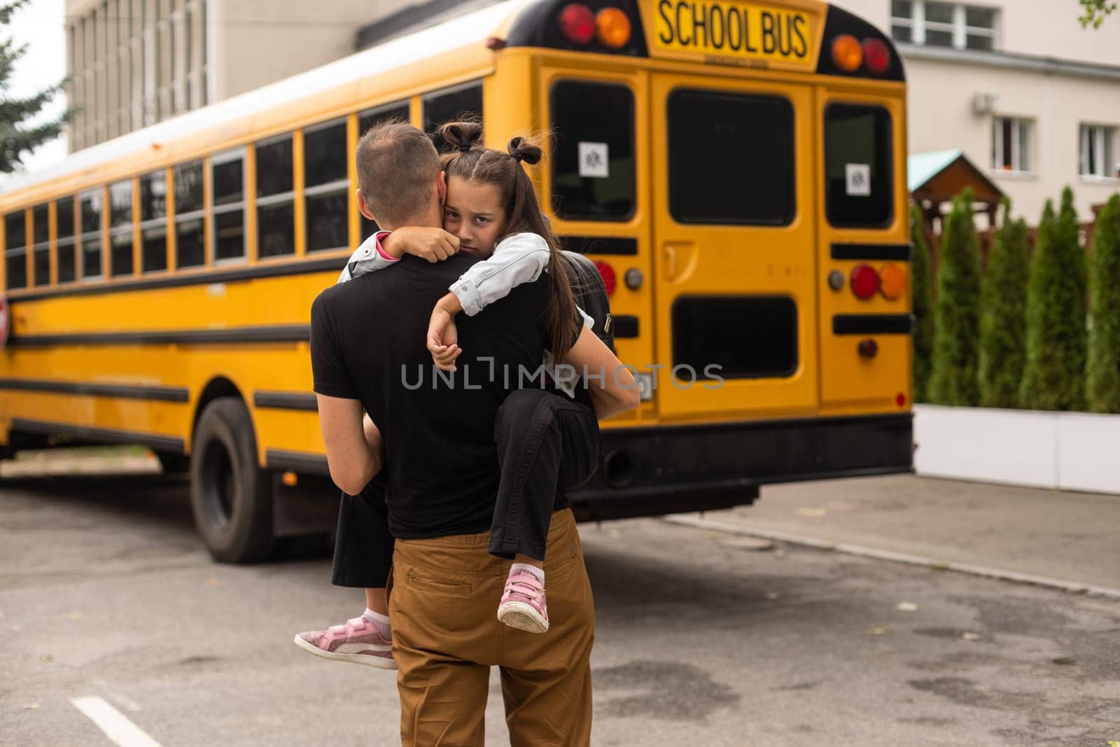 Cute little girl going to school with her father.