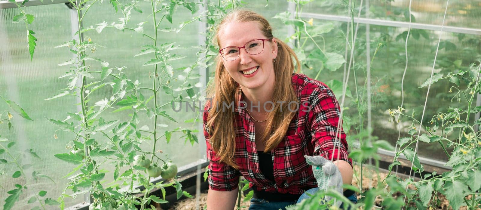 Woman working inside greenhouse garden - Nursery and spring