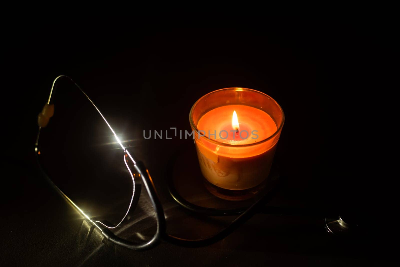 Burning light candle with stethoscope.