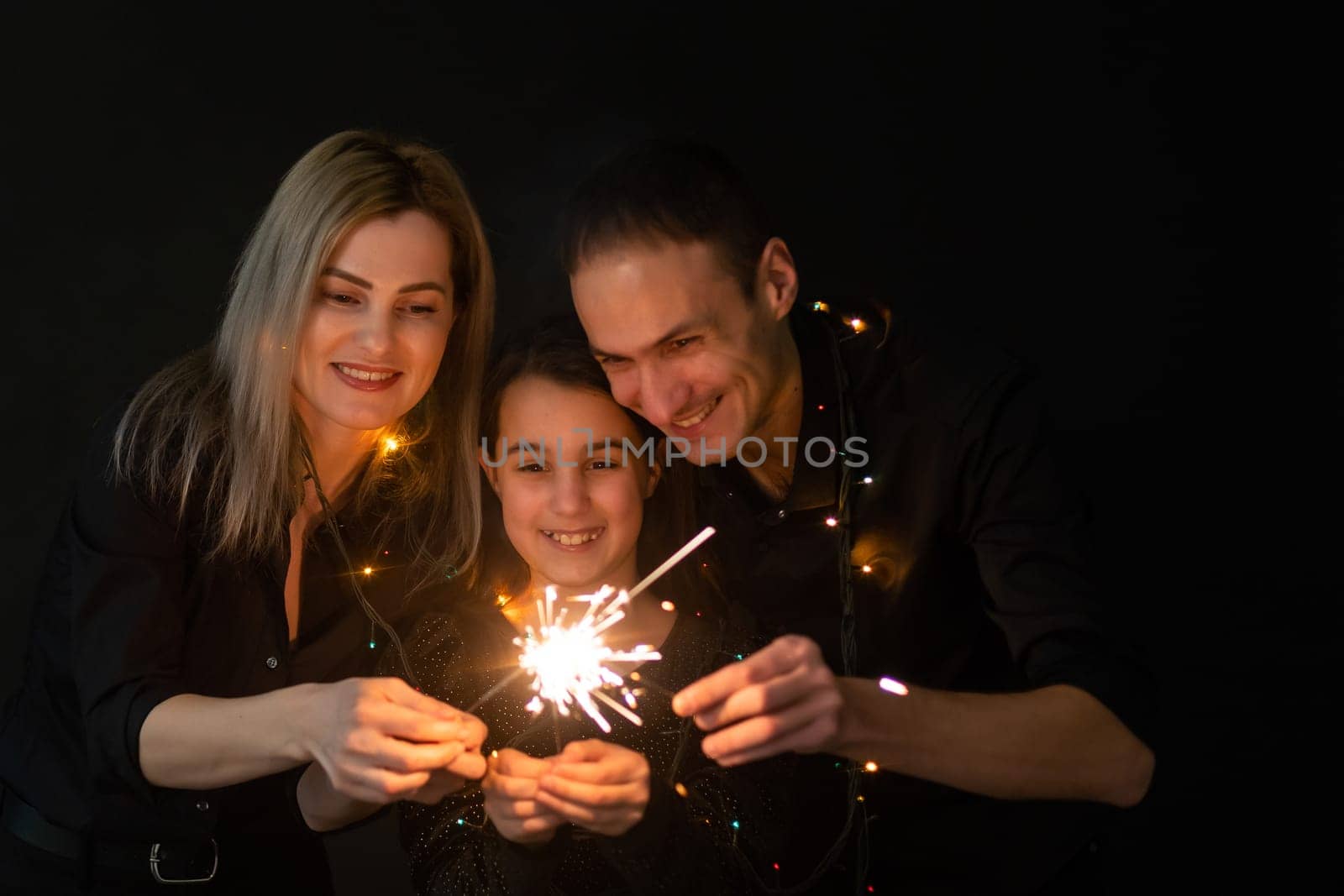 family with garland on a black background by Andelov13