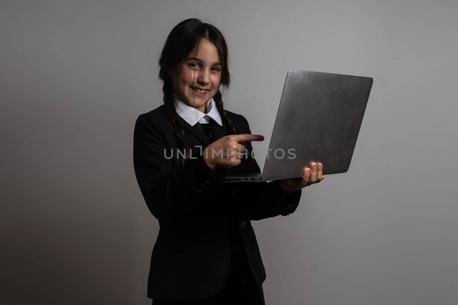 a girl in a black dress, Wednesday girl with a laptop.