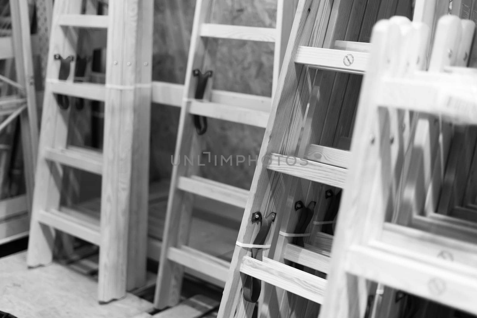 Many Wooden ladders. Stack of wooden stairs in the store.