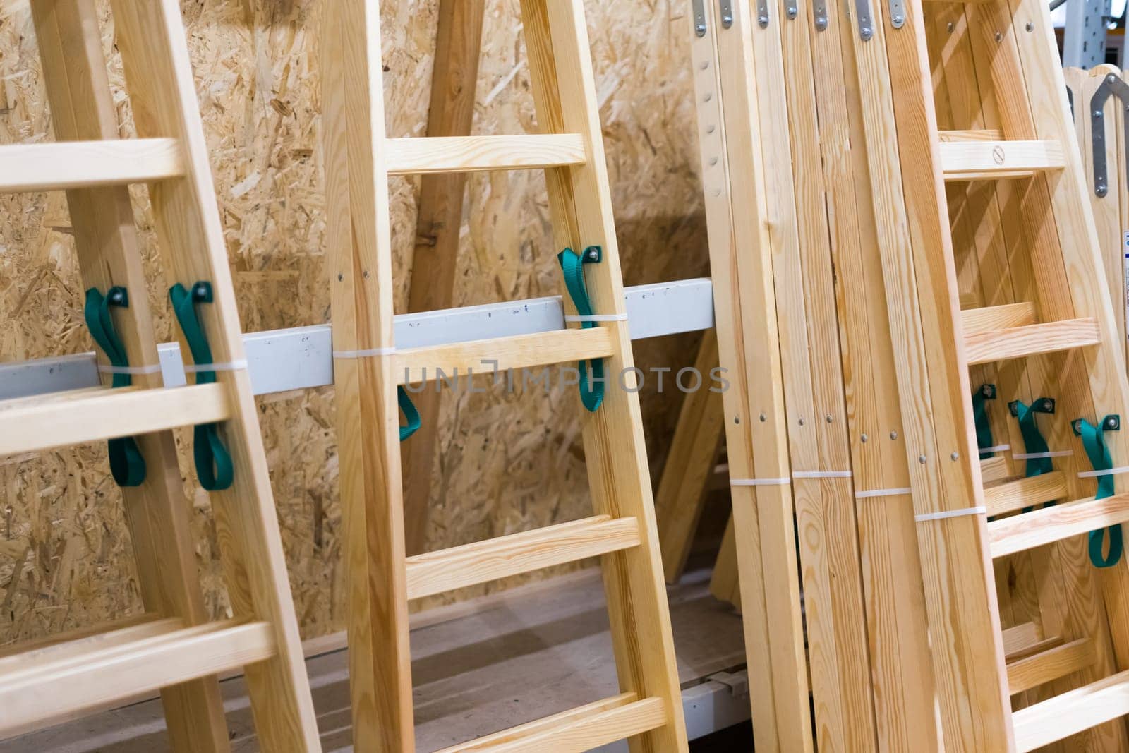 Many Wooden ladders. Stack of wooden stairs in a store. by Zelenin