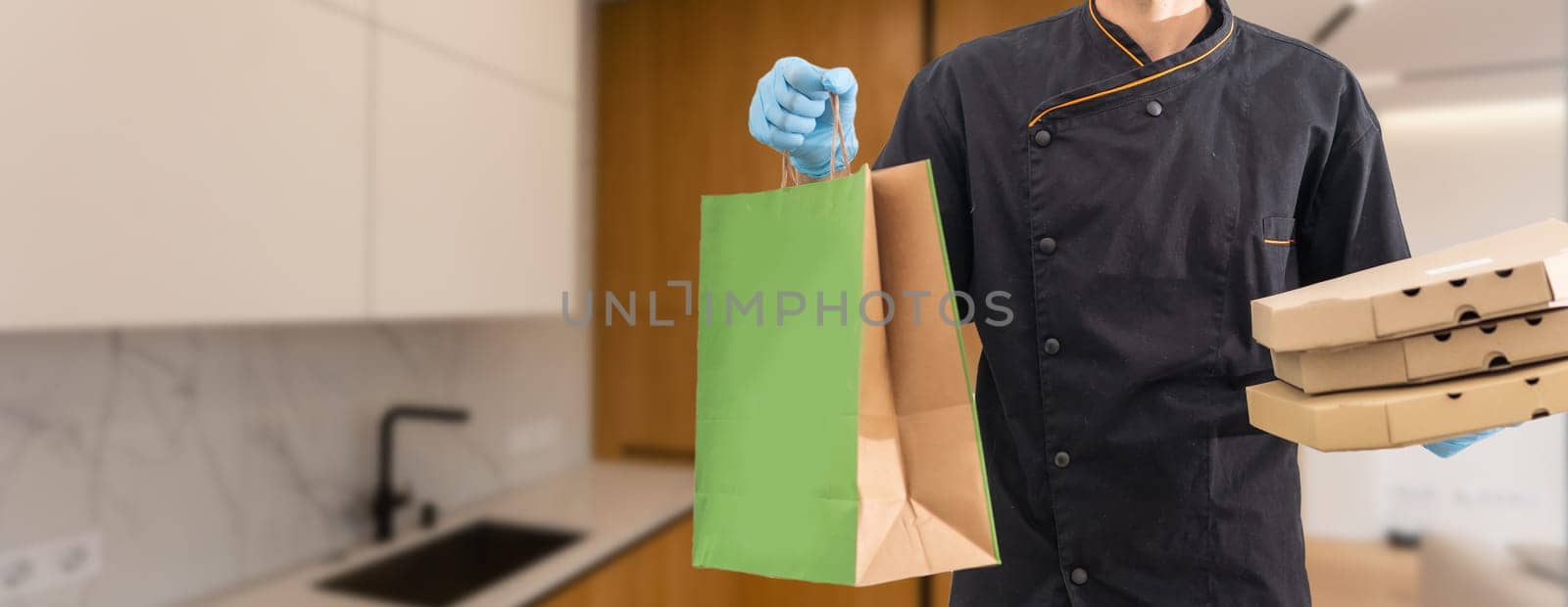 Diverse of paper containers for takeaway food. Delivery man is carrying pizza.