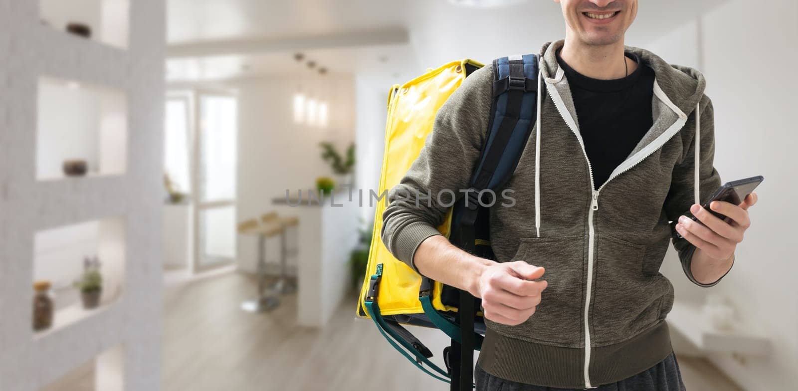 delivery guy employee man workwear yellow thermal food bag backpack work as dealer courier. Service concept.
