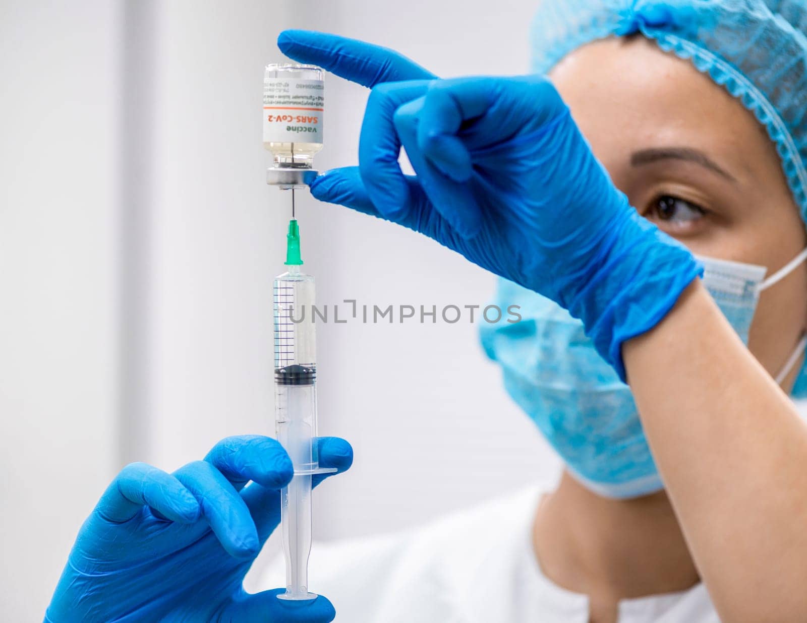 Doctor prepares a syringe with an injection, close-up