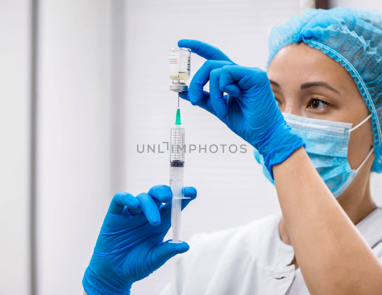 Doctor prepares a syringe with an injection, close-up